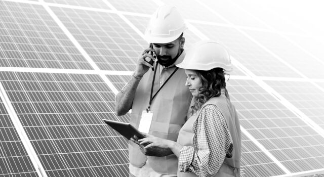 SINGLE-IMAGE_two-workers-hard-hats-tablet-solar-panels_nov23