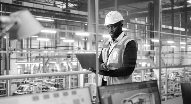 SINGLE-IMAGE_man-hard-hat-in-factory-with-laptop_oct23