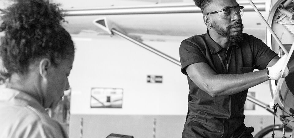 SINGLE-IMAGE_airplane-mechanic-repairing-with-digital-tablet_apr25