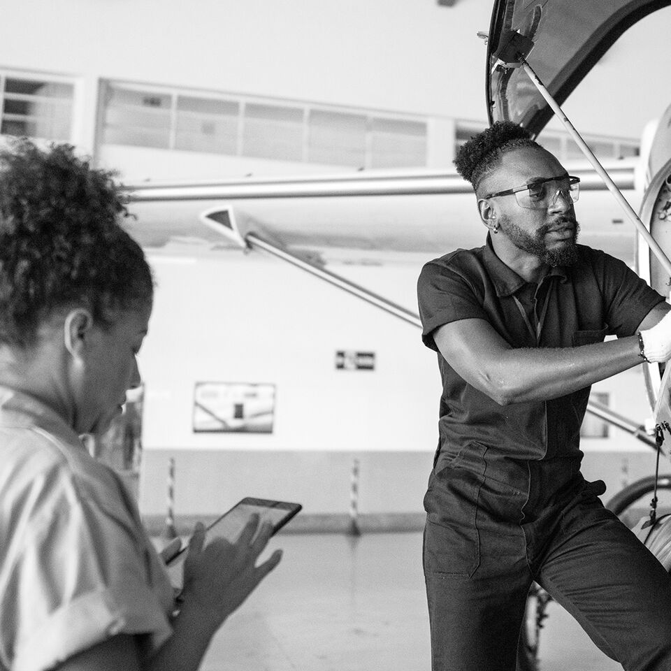 SINGLE-IMAGE_airplane-mechanic-repairing-with-digital-tablet_apr25