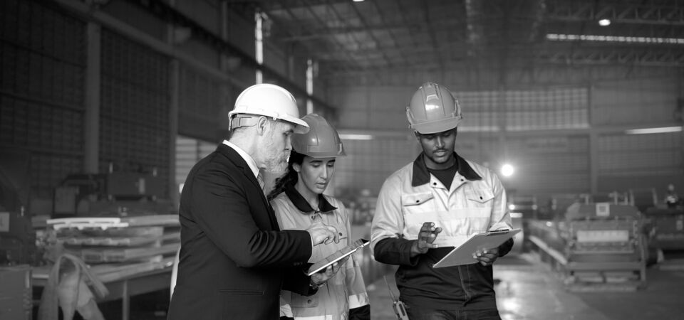 SINGLE-IMAGE_group-with-hard-hats-studying-tablet-and-clipboard_apr25