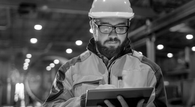 SINGLE-IMAGE_man-with-hard-hat-looking-at-tablet-no-squares_mar24